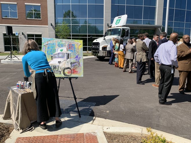 A painter illustrates the scene outside of IMC Companies' new headquarters in Collierville on April 27, 2022. Mark George founded IMC Company in 1982 to provide services including marine drayage, expedited services, truck brokerage, warehousing and more.