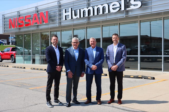 Matt Willis, Mark Hummel, Rich Willis and Jason Willis stand for a photo in front of Hummel's Nissan at 4770 Merle Hay Road, Des Moines.
