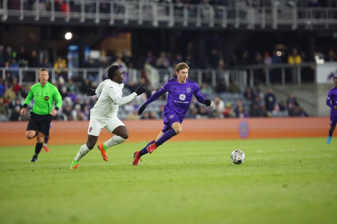 Louisville City FC forward Wilson Harris shakes off a defender against Indy Eleven