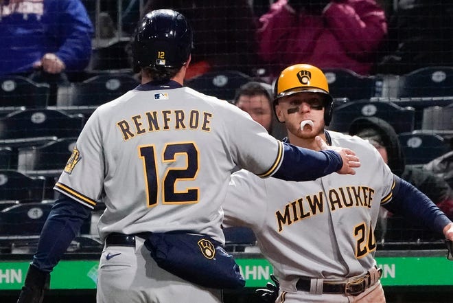 The Brewers' Hunter Renfroe  is greeted by Mike Brosseau after scoring on a hit by Tyrone Taylor in the seventh inning Wednesday night against the Pirates.