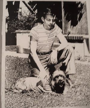 Roberty Coyne poses with Devil, the dog he adopted from the battlefields of World War II.