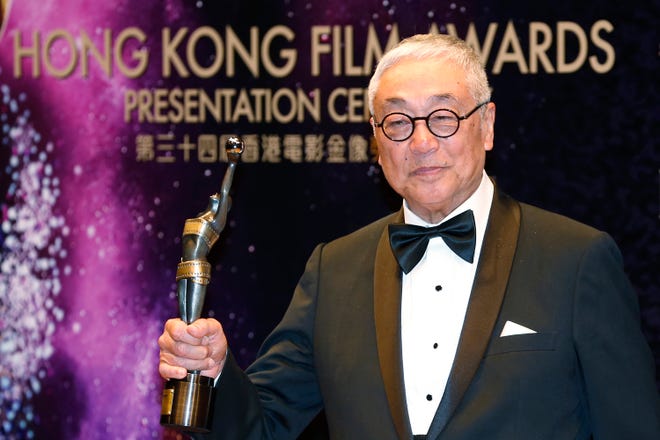 FILE -Hong Kong actor Kenneth Tsang poses after winning the Best Supporting Actor award for his movie "Overhead 3" during the Hong Kong Film Awards in Hong Kong Sunday, April 19, 2015. Hong Kong media reported that Tsang was found dead Wednesday in his quarantine hotel room after arriving from Singapore. (AP Photo/Kin Cheung, File) ORG XMIT: XKC101
