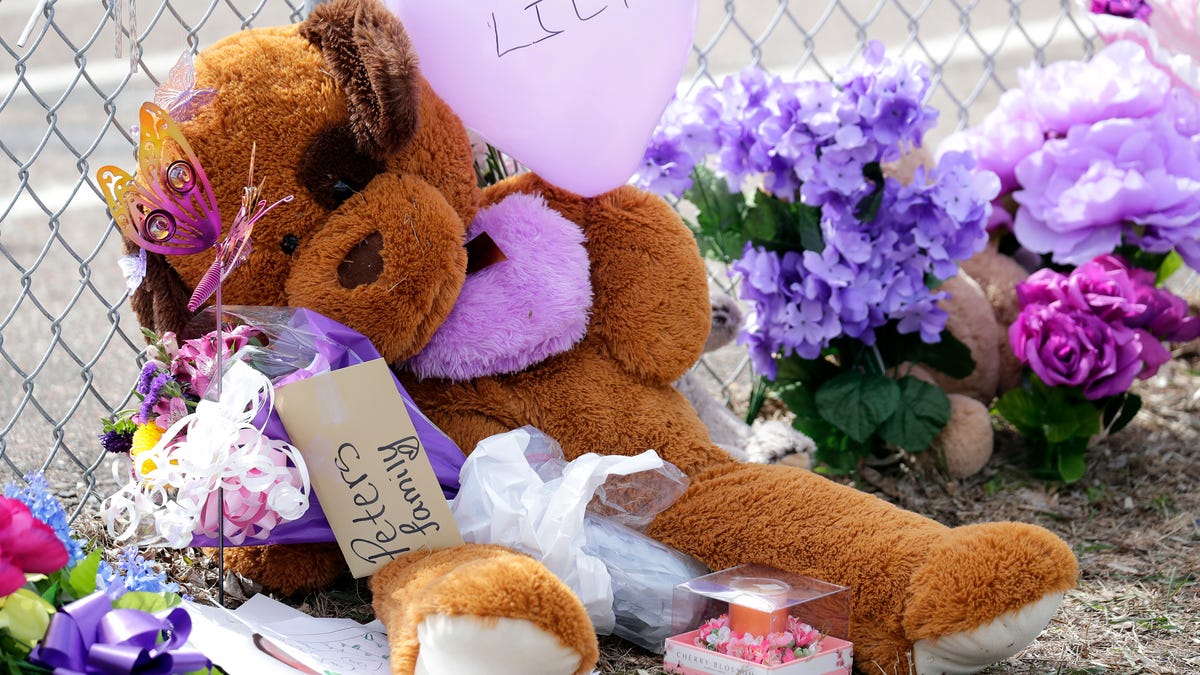 Stuffed animals, flowers, balloons and other items make up a memorial in front of Parkview Elementary School as offiicials continue to investigate the homicide of Iliana "Lily" Peters, 10, Tuesday, April 26, 2022, in Chippewa Falls, Wis.