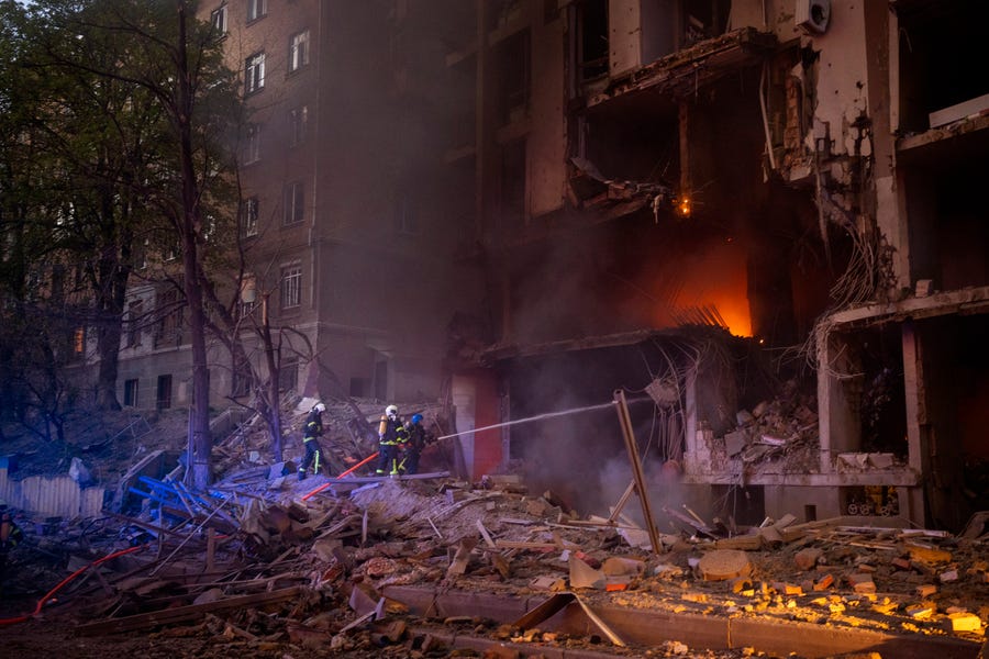 Firefighters try to put out a fire following an explosion in Kyiv, Ukraine on Thursday, April 28, 2022. Russia mounted attacks across a wide area of Ukraine on Thursday, bombarding Kyiv during a visit by the head of the United Nations. (AP Photo/Emilio Morenatti) ORG XMIT: EM128