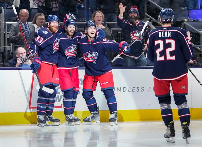 Columbus Blue Jackets center Jack Roslovic (96) celebrates scoring a goal with right wing Jakub Voracek (93), right wing Oliver Bjorkstrand (28) and defenseman Jake Bean (22) during the third period of the NHL game against the Tampa Bay Lightning at Nationwide Arena in Columbus on April 28, 2022. The Blue Jackets won 5-2.
