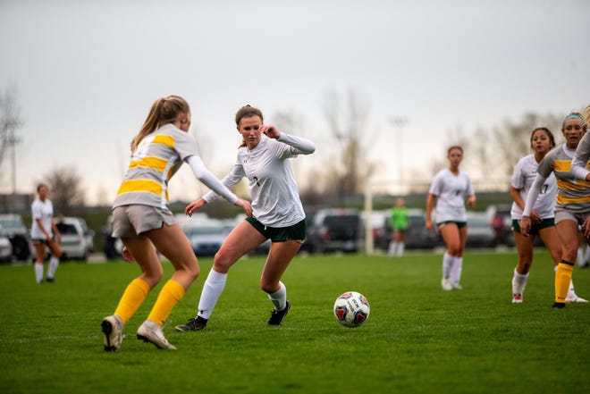 West's Abby Winn takes the ball towards the goal during a game against Zeeland East Thursday, April 28, 2022, at Zeeland East High School. Winn finished the game with five goals. 