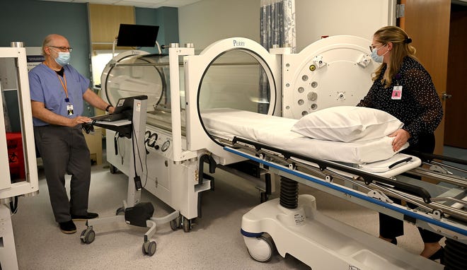 Dr. Elliot Lach, left, and program director Carolyn Blaney show one of two new  hyperbaric chambers during a tour of a new wound healing and hyperbaric center at MetroWest Medical Center in Framingham, April 28, 2022.  
