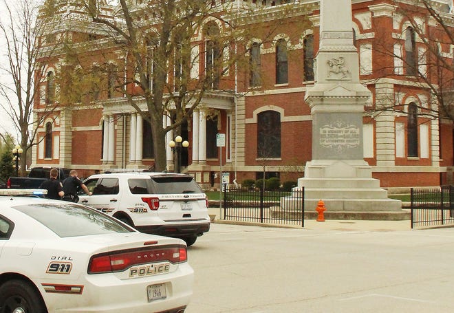 Pontiac Police officers block off the intersection at North Main and East Madison streets at the Historic Livingston County Courthouse Friday morning. According to Sheriff Jeff Hamilton, a bomb threat was made the County Clerk's office, which is shown behind the monument, around 10 a.m. The building and other downtown buildings were evacuated and remained so until nearly 2:30 p.m. when the all-clear was given. No explosive device was found.