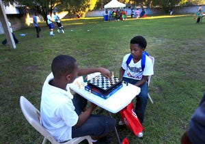 A game of chess is played during a festival outside the Martin Luther King Jr. Multipurpose Center in Gainesville, in 2013