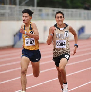 Abilene High's Andruw Villa (right) runs next to El Paso Eastwood's Andres Gurrola in the boys 3,200 at the Region I-6A track and field meet in Arlington on Friday.