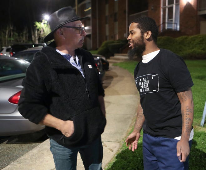 Mark Purnell (right) talks with attorney Herb Mondros after Purnell was released from prison Thursday, April 28, 2022. Purnell, now 32, had been incarcerated since age 16 but his conviction was overturned ten months ago.