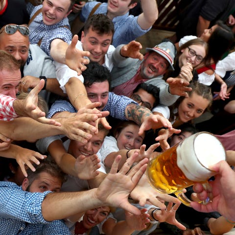 People reach for a glass of beer during the openin