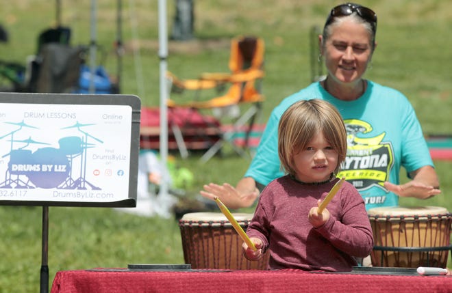Three-year-old Brock Doberstein works on his drumming technique at the Drums By Liz booth during the Garibaldi Festival held Saturday, April 30, 2022, at Stowe Park in Belmont.