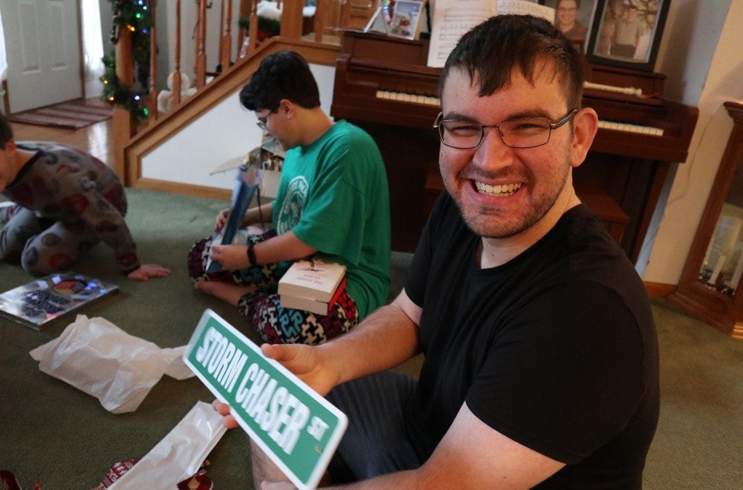 Gavin Short, 19, is pictured holding a storm chaser sign he was gifted with at Christmas in December 2021.