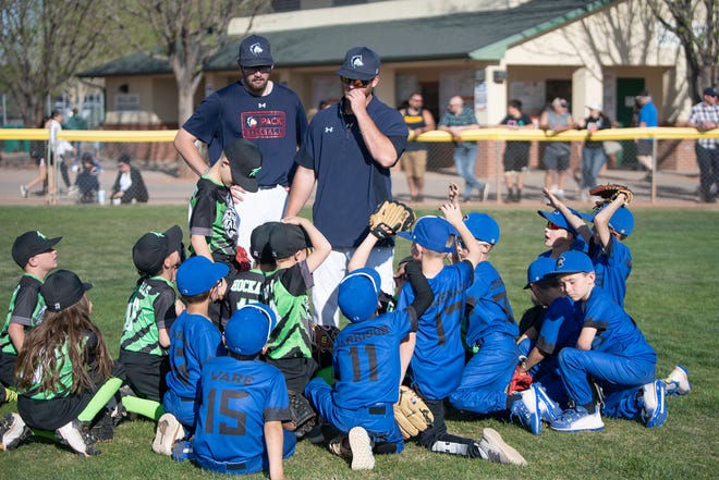 Colorado State University Pueblo baseball players talk to a group of kids at the 17th annual Art & Lorraine Gonzales youth clinic and Pack the Park event at the Runyon Sports Complex on Friday, April 29, 2022.