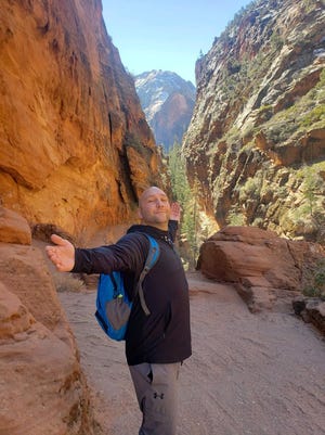 Jeremy Marchek poses for a photo while visiting Zion National Park in Utah. Marchek, 42, was killed in a Clinton County crash last week.