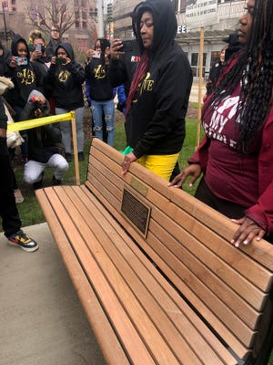 Maria Hamilton, left, stands with Milwaukee County Supervisor Sequanna Taylor at the unveiling of the memorial bench for Dontre Hamilton Saturday in Red Arrow Park.