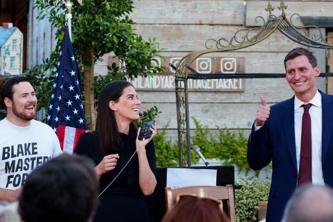 Christina Bobb, now a top Trump lawyer, and Blake Masters speak to former President Donald Trump on the phone during Masters' election integrity event at American Way Smokehouse on April 30, 2022, in Chandler.