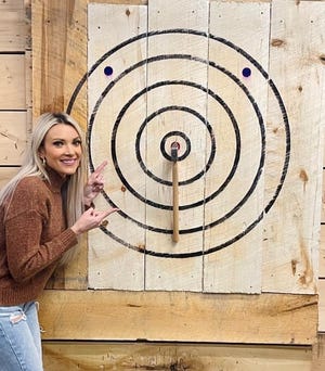 A customer celebrates hitting the bull's-eye at Steel City Axe in Johnstown.