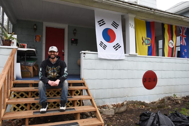 "To be here is to be blessed," Umoja House resident Chris Stauffer, 42, of Lansing says while sitting on the front porch of the home he's lived in since March.