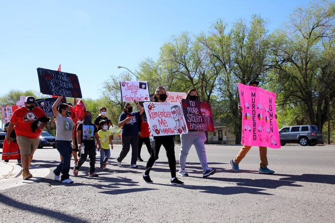 The Missing and Murdered Indigenous Women Memorial Honor Walk on May 5, 2021 moves along U.S. Highway 64 in Shiprock.