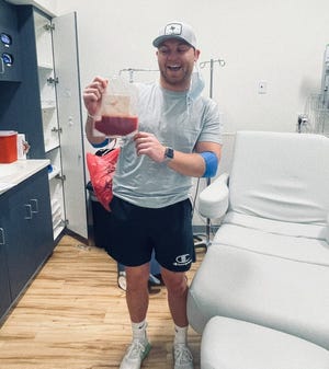 Ethan Case, a South Dakota State University doctor of pharmacy student, poses with the peripheral blood stem cells he donated to a leukemia patient he didn't know in Seattle, Washington in March 2022.