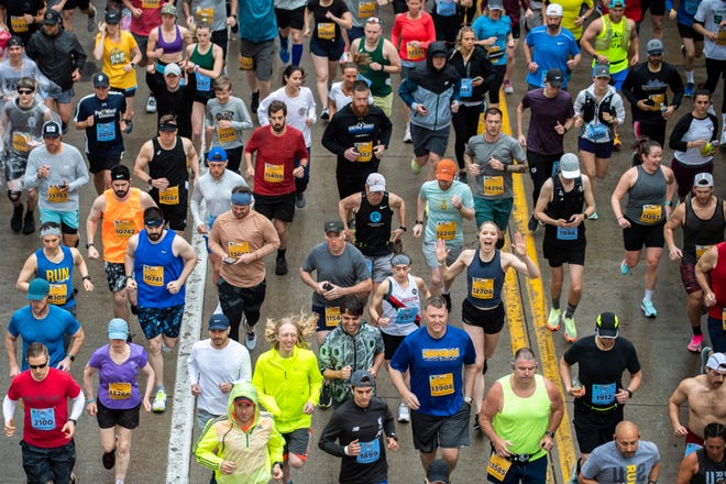 Runners start off a marathon on May 1, 2022, in downtown Pittsburgh.
