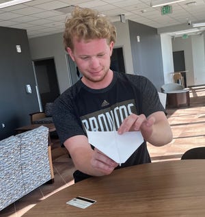 Western Michigan University aviation student Evin Cooper prepares his record-setting paper airplane.