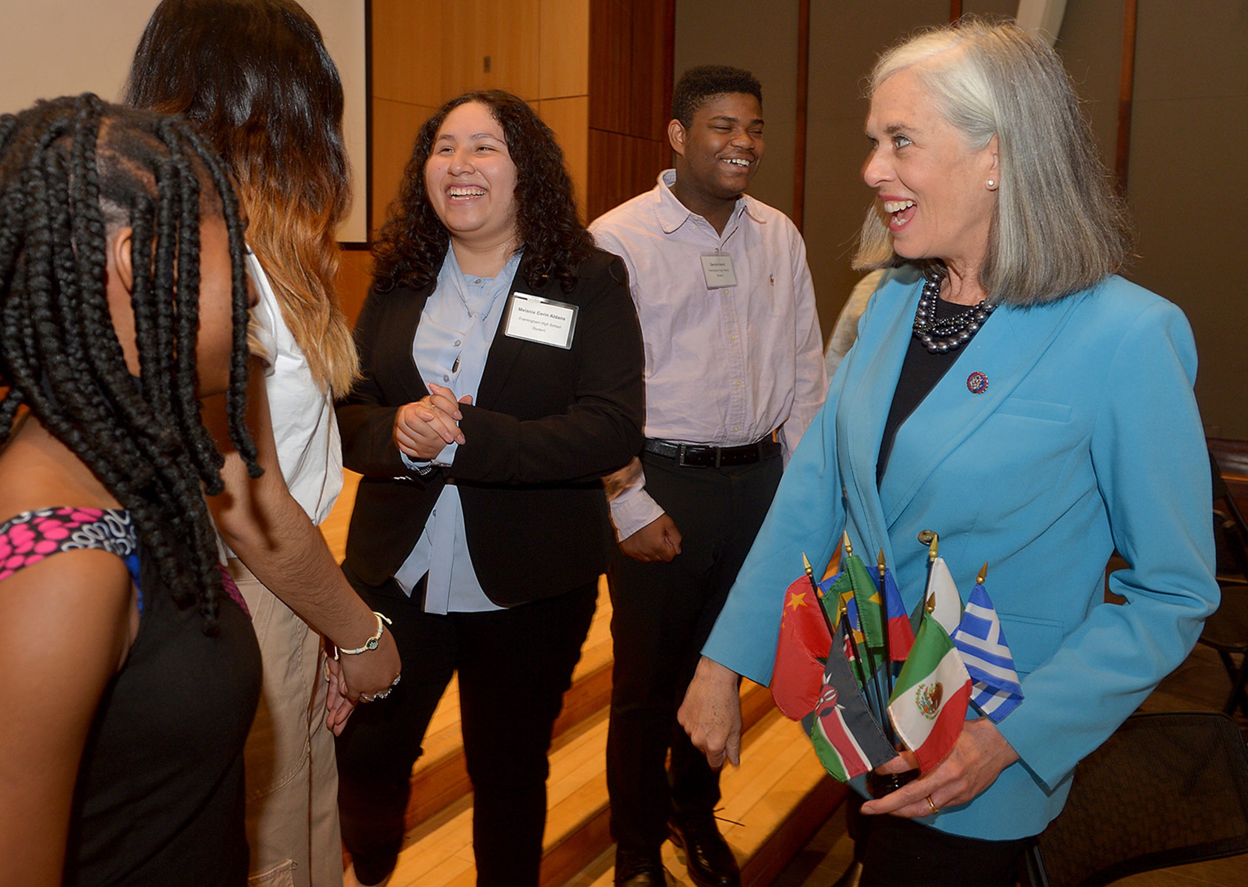 Rep. Katherine Clark, Assistant House Speaker, right,  smiles after a fist bump with Framingham High School student Melanie Cerin Aldana, center, after Clark announced a $600,000 expansion of the MetroWest Scholars Early Start program, early college funding for Waltham students,  at Framingham State University, May 3, 2022.  From left: Melody Obi-Ngo, Waltham; Dayana Alvarado Perez, Framingham; Aldana; Derrick Vervil, of Framingham, and Clark.