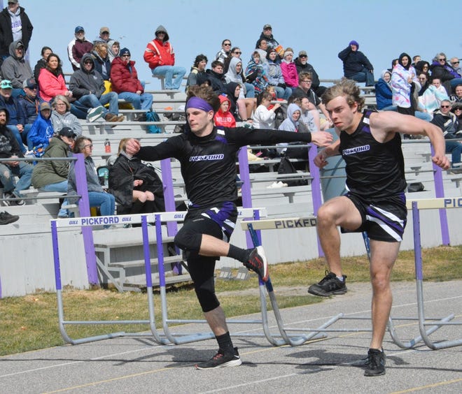 Pickford's Josh Sullivan, left, and Caden Awbrey, right, were locked in a photo finish in the boys 110 high hurdles at the Web Morrison Invitational Saturday. Awbrey won the event and he and Sullivan placed 1-2 in both the 110 and 300 hurdles.