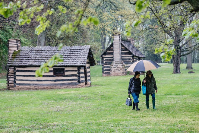 Women walk the grounds of the Historic Schoenbrunn Village in New Philadelphia in this file photo. The Dennison Railroad Depot Museum is turning back management of the site to the Ohio History Connection in Columbus