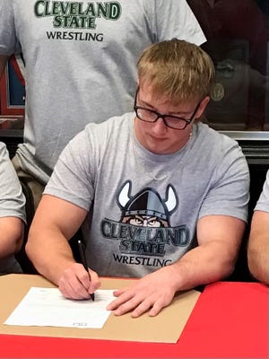 Pleasant senior C.J. Smith signs to continue his wrestling career at Cleveland State Tuesday afternoon in the lobby of Stan Kirby Gymnasium.