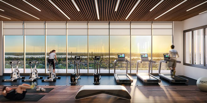 The Aura's rooftop fitness center features floor-to-ceiling windows that add to the great weather views.