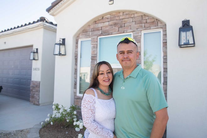 Tammy Hicks and Jake Glossop smile in front of their new house in Las Cruces on Friday, April 29, 2022. The couple and their home was featured on an episode of the TV show "House Hunters."