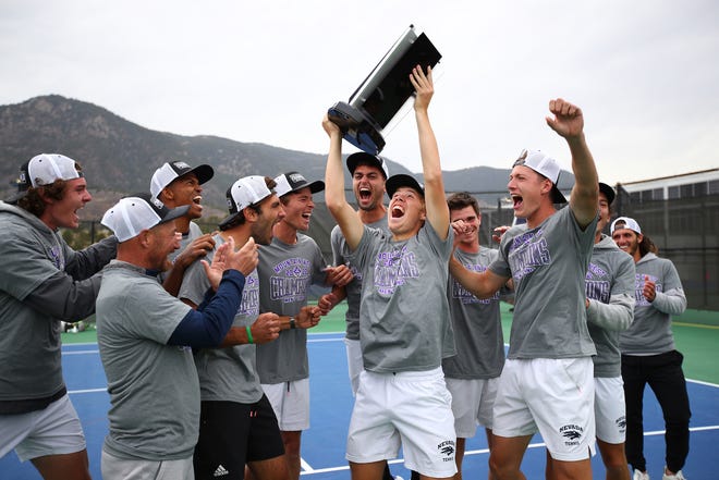 The Nevada men's tennis team swept the Mountain West's regular-season and tournament titles. Here, the team celebrates its MW tournament title win on Sunday.