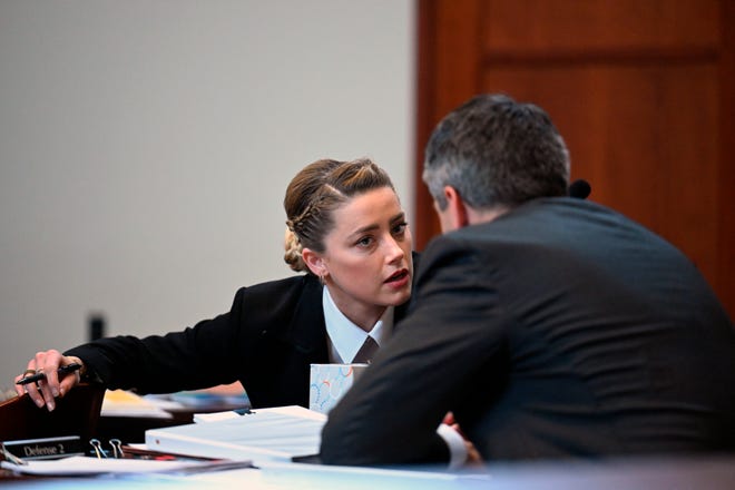 Amber Heard talks to her attorneys during trial on May 2.