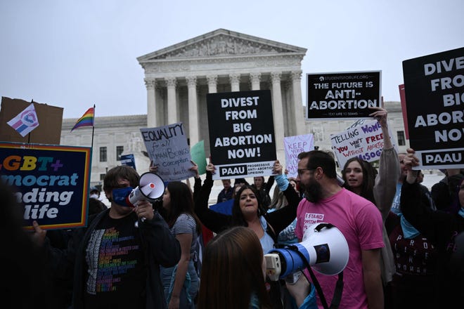 Demonstrators gathered in front of the U.S. Supreme Court on May 3 after a draft opinion was leaked that indicated Roe v. Wade would be overturned after nearly 50 years.
