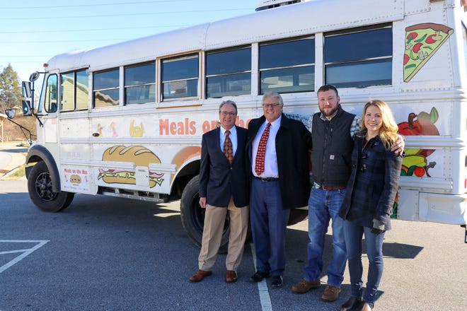 This photo from December 2019 features (from left) Robert Rolfe, former HCPS superintendent Bo Caldwell and Brian and Gina Grossman. Through the Grossmans' donation to the Henderson County Education Foundation, the HCPS Child Nutrition Department provided more than 3,500 meals to children facing food insecurity during the 2019 winter break. Called the "Comfort Food" initiative, this was a precursor to the expanding the district's "Meals on the Bus" mobile feeding program in 2020 to serve students during the pandemic.