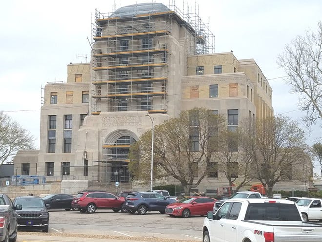 The current Reno County courthouse in 2022 with the exterior covered in scaffolding as it is being renovated because of earthquake damage. 