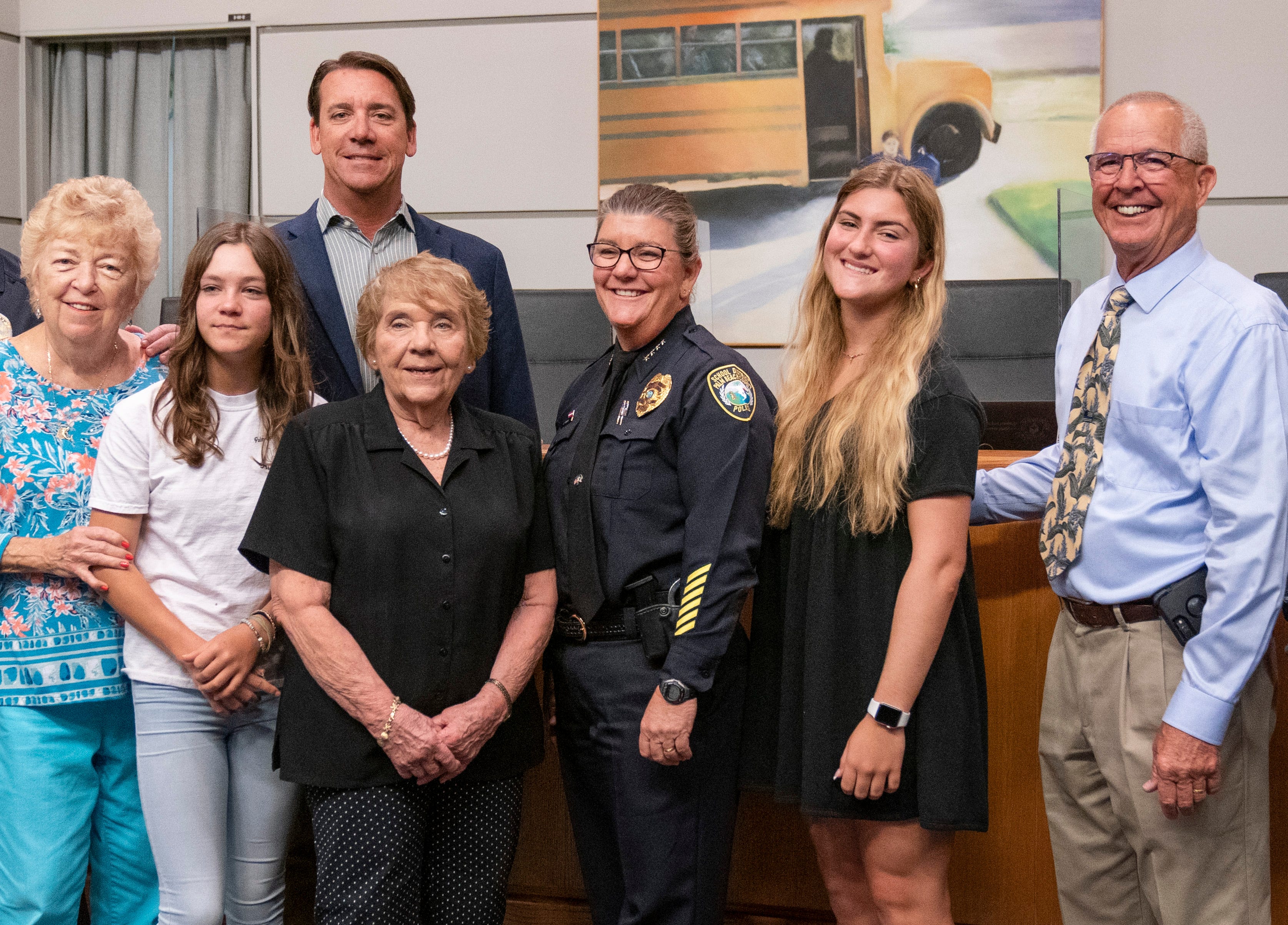 Sarah Mooney gets photos with her family after being sworn in as the new Chief of the Palm Beach County School Police at a ceremony at district headquarters in West Palm Beach, Florida on May 4, 2021.