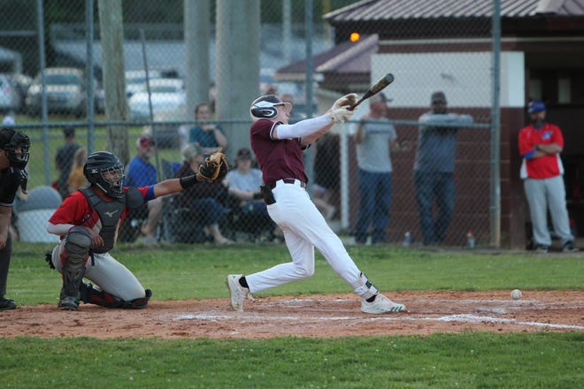 Senior Briggs Barker sends a grounder toward left field against Madison on May 3.