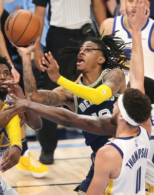 Memphis Grizzlies guard Ja Morant shoots the ball over Golden State Warriors guard Klay Thompson during game two of the second round for the 2022 NBA playoffs at FedExForum on Tuesday, May 3, 2022.