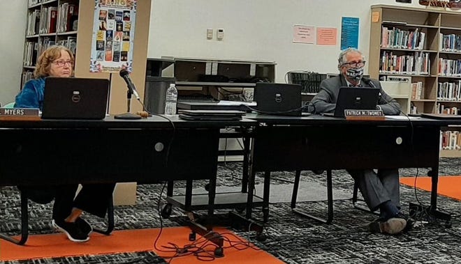 Dr. Jill Joline-Myers, left, and Dr. Patrick M. Twomey listen during a presentation to the Macomb school board Monday, April 25, 2022.