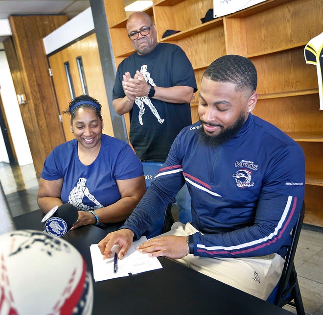 Lori and Andre Thames watch their son Fabian, 23, sign his contract. The former Randolph High football standout signs a professional rugby contract with the American Raptors in Colorado in front of many Randolph High athletes on Thursday, May 5, 2022.
