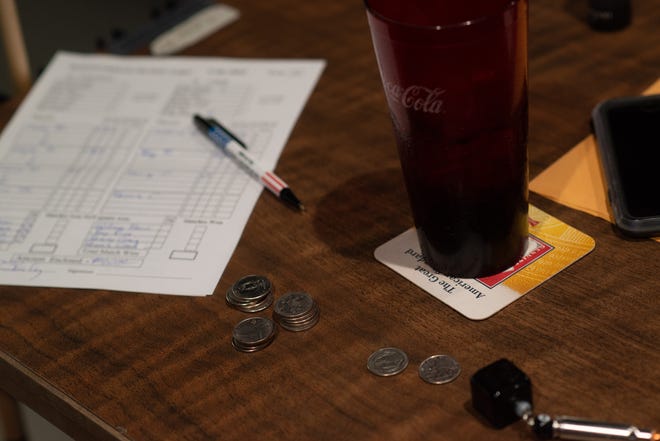 Five quarters and a scorecard are seen on a table of pool players at Boulevard Billiards.