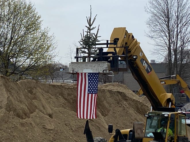 The final vertical beam, with a traditional pine tree sitting on top, is lifted into place during a “topping off” ceremony for the new Leominster police station April 25. The beam was signed by members of the Leominster City Council, Police Station Building Committee and the Police Department, along with Leominster Mayor Dean Mazzarella.