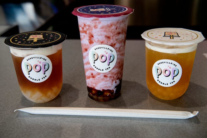 From left, a lychee black tea with jelly, a signature Purple Dragon, and a fruit tea with passion fruit and mango popping balls.