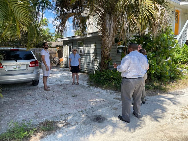 William and Sara Burke speak with members of Fort Myers Code Enforcement on April 28 about a violation on their property that has since been resolved.