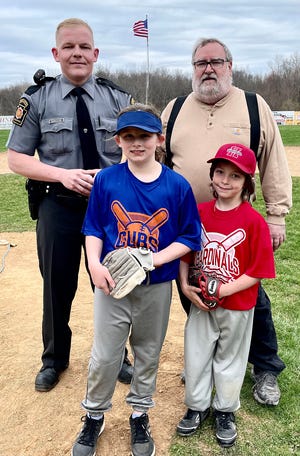 Hundreds of local fans gathered at Fred Reisch Memorial Field this week to celebrate Opening Days of the Honesdale Little Baseball Association season. Pictured here is Pennsylvania State Trooper and HLBA alum Rob Borkowski after throwing out the ceremonial first pitch. He’s shown with league president Charlie Rollison along with Joe LaTournas of the Cardinals and Gwendolyn Tallman of the Cubs.