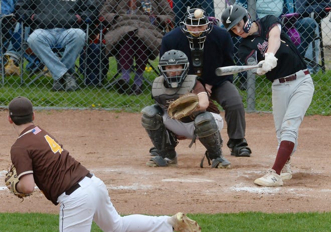 Andrew Aspden hits a double off a pitch from Titusville High School's Garrett Knapp, left, in North East in this May 2022 photo. Aspden plays left field and third base and sometimes pitches for North East. Off the field, he's an entrepreneur.